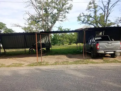 a truck parked under a shed next to a motorcycle at Kempes, Ferial Chateau in Cordoba