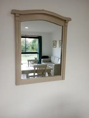 a mirror reflecting a living room with a table and a couch at Kempes, Ferial Chateau in Cordoba