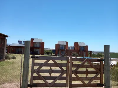 a gate in front of a row of houses at Remanso Los Molinos in Potrero de Garay
