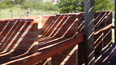 a brick retaining wall with its shadows on it at Remanso Los Molinos in Potrero de Garay