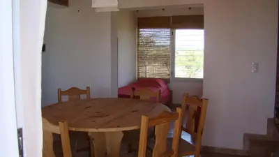 a dining room with a wooden table and chairs at Remanso Los Molinos in Potrero de Garay