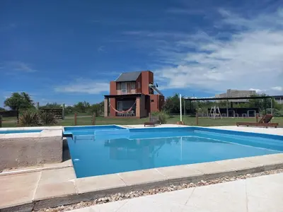 a swimming pool in front of a house at Remanso Los Molinos in Potrero de Garay