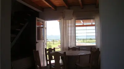 a dining room with a table and a window at Remanso Los Molinos in Potrero de Garay
