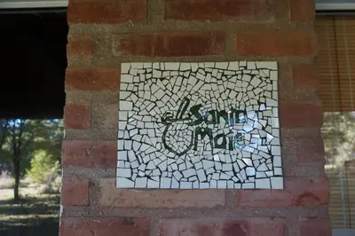 a mosaic tile on the side of a brick wall at Santa Mate in Nono