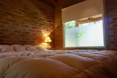 a large bed in a room with a window at Santa Mate in Nono