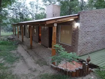 a brick house with a porch and a window at Santa Mate in Nono