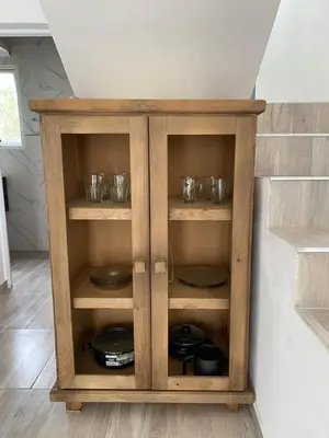 a wooden cabinet with plates and dishes in it at cuatro vientos 1 in Santa Rosa de Calamuchita