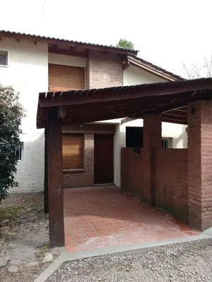 a brick house with a large patio in front of it at Santa Julia in Villa General Belgrano