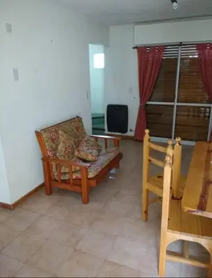 a living room with a couch and a tv at Santa Julia in Villa General Belgrano