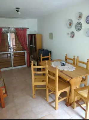 a dining room with a wooden table and chairs at Santa Julia in Villa General Belgrano