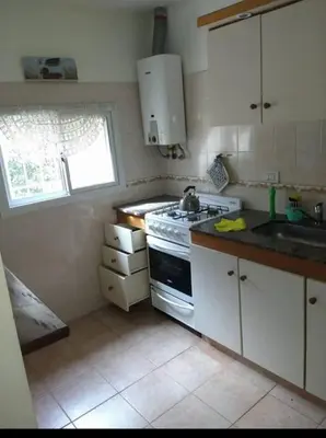 a kitchen with a stove and a sink and a window at Santa Julia in Villa General Belgrano