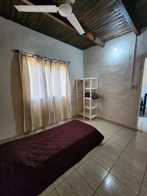 a bedroom with a bed and a ceiling fan at La Vivi in Villa Larca