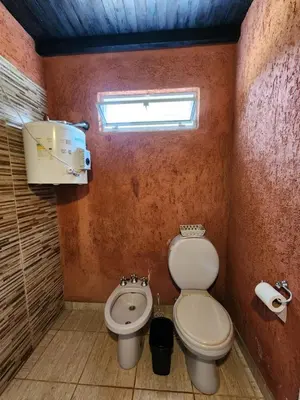a small bathroom with a toilet and a sink at La Vivi in Villa Larca