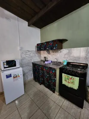 a kitchen with a stove and a sink and a refrigerator at La Vivi in Villa Larca