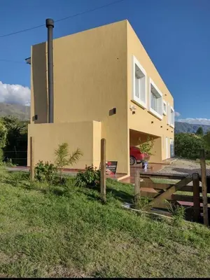 a house with a fence in front of it at Bienamada in Merlo