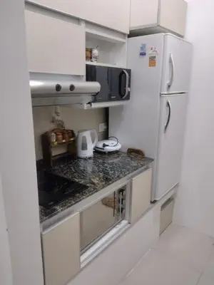 a kitchen with a white refrigerator and a counter at Bienamada in Merlo