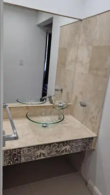 a bathroom with two mirrors on a counter at Bienamada in Merlo