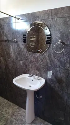 a bathroom with a sink and a mirror on the wall at Lo de Andrés y Marina in Arroyo de Los Patos