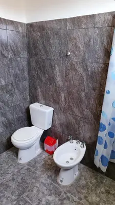 a bathroom with a toilet and a sink at Lo de Andrés y Marina in Arroyo de Los Patos