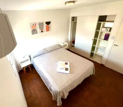 a bedroom with a bed with a book on it at DEPARTAMENTO CENTRAL in Cordoba