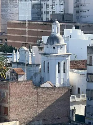 a white clock tower on top of a building at DEPARTAMENTO CENTRAL in Cordoba