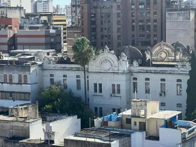 a white building with a palm tree on top of it at DEPARTAMENTO CENTRAL in Cordoba