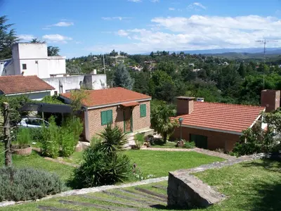 a small house with a yard at Petit House in Villa Carlos Paz