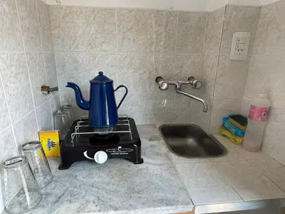 a kitchen counter with a blue kettle on a blender at Petit House in Villa Carlos Paz