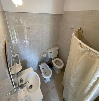 a bathroom with a sink and a toilet and a shower at Petit House in Villa Carlos Paz