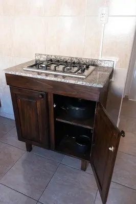 a kitchen with a stove top in a cabinet at Punto Golondrina in Alta Gracia