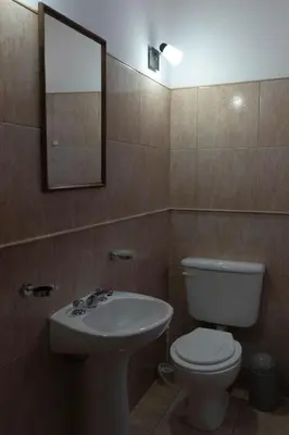 a bathroom with a toilet and a sink and a mirror at Punto Golondrina in Alta Gracia