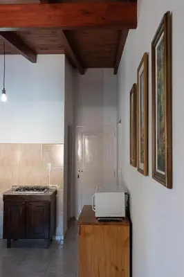 a kitchen with a counter with a microwave on a table at Punto Golondrina in Alta Gracia