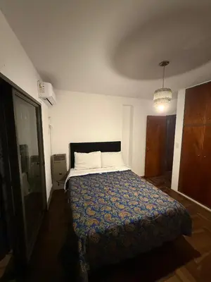 a bedroom with a large bed in a room at Departamento del Río - Late CheckOut in Cordoba