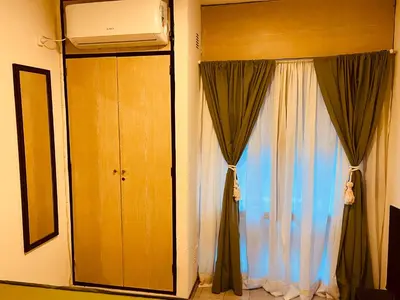 a room with a curtain and a window with a television at Departamento moderno Zona centro in Cordoba