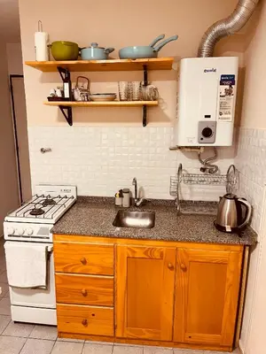 a kitchen with a stove and a sink at Departamento moderno Zona centro in Cordoba