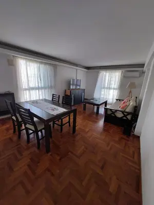 a living room with a table and chairs and a couch at HERMOSO DEPARTAMENTO a 3 cuadras del PATIO OLMOS Dos dormitorios in Cordoba