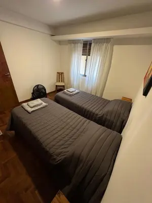 a hotel room with two beds and a window at HERMOSO DEPARTAMENTO a 3 cuadras del PATIO OLMOS Dos dormitorios in Cordoba