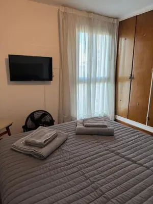 a bedroom with a bed with two towels on it at HERMOSO DEPARTAMENTO a 3 cuadras del PATIO OLMOS Dos dormitorios in Cordoba