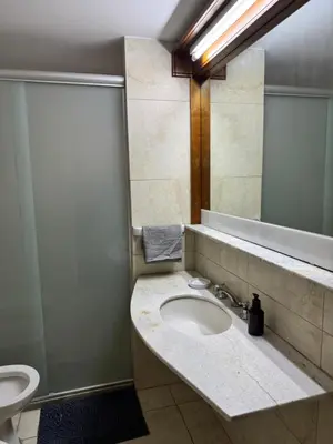 a bathroom with a sink and a mirror at HERMOSO DEPARTAMENTO a 3 cuadras del PATIO OLMOS Dos dormitorios in Cordoba