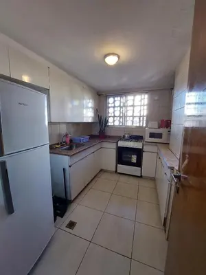 a kitchen with white cabinets and a white refrigerator at HERMOSO DEPARTAMENTO a 3 cuadras del PATIO OLMOS Dos dormitorios in Cordoba