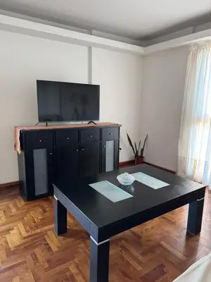 a living room with a black table and a flat screen tv at HERMOSO DEPARTAMENTO a 3 cuadras del PATIO OLMOS Dos dormitorios in Cordoba