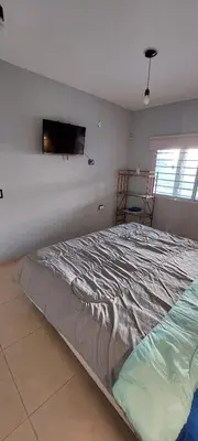 a bedroom with a bed with a tv on the wall at Casa de Descanso Valle Escondido in Cordoba
