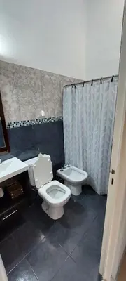 a bathroom with a toilet and a sink and a shower at Casa de Descanso Valle Escondido in Cordoba