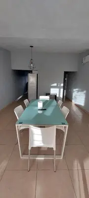 a dining room with a green table and white chairs at Casa de Descanso Valle Escondido in Cordoba