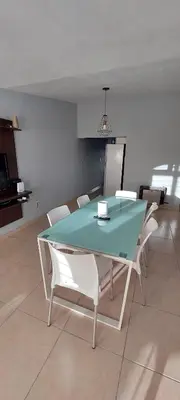 a dining room with a glass table and white chairs at Casa de Descanso Valle Escondido in Cordoba