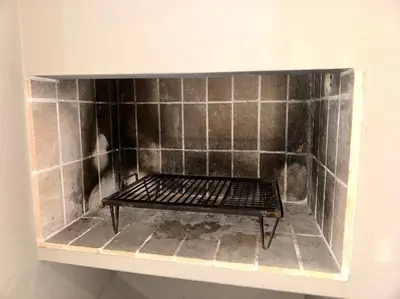 a tiled fireplace with a shelf in a room at Departamento Altas in Cordoba