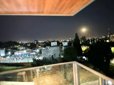 a view of a city at night from a balcony at Departamento Altas in Cordoba