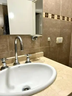 a white sink in a bathroom with a mirror at Departamento Altas in Cordoba