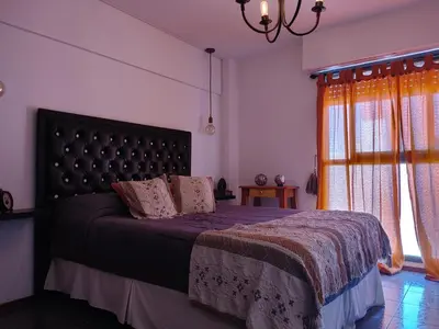a bedroom with a large bed and a window at Departamento Urquiza 269 in Cordoba