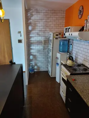 a kitchen with a stove and a refrigerator at Departamento Urquiza 269 in Cordoba